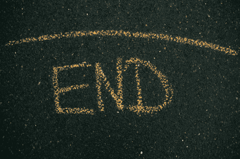 the word "end" scrawled on asphalt