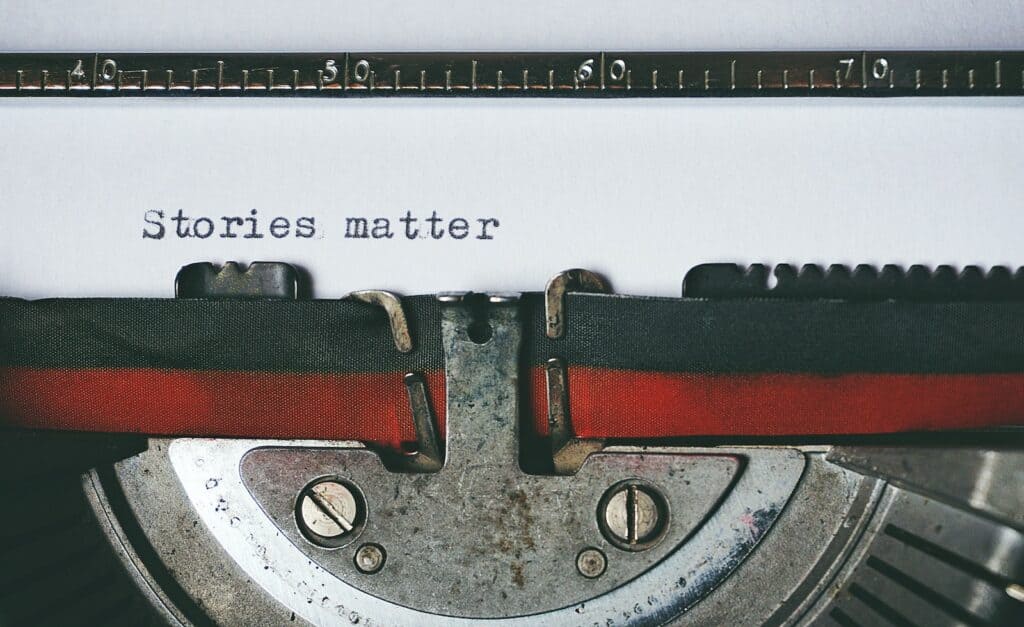 Black and Red Typewriter that says stories matter