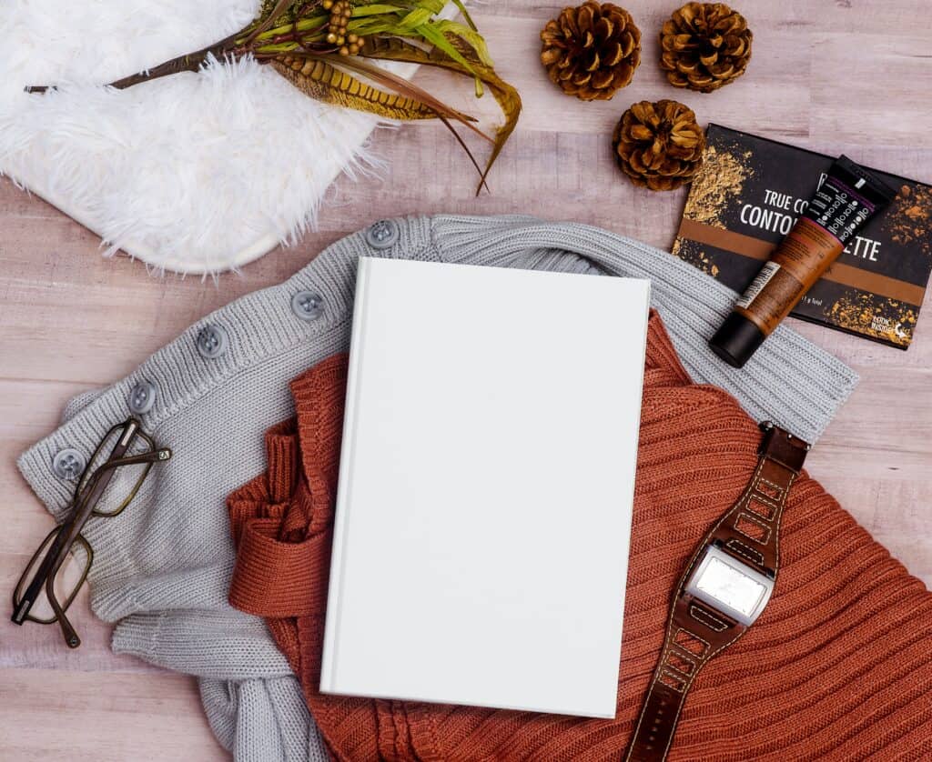 a book with a blank cover with a couple of personal items