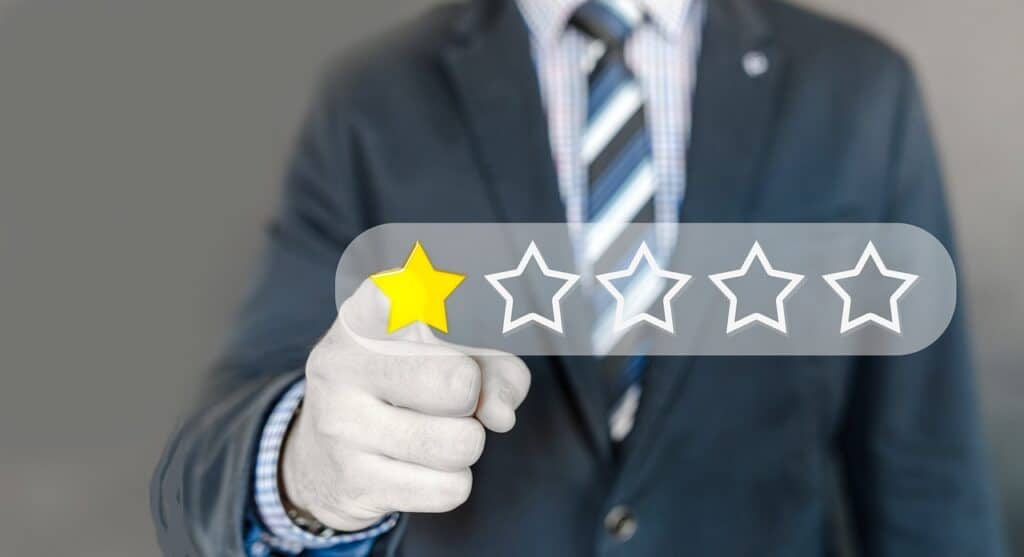 person pointing at one star on a five-star system