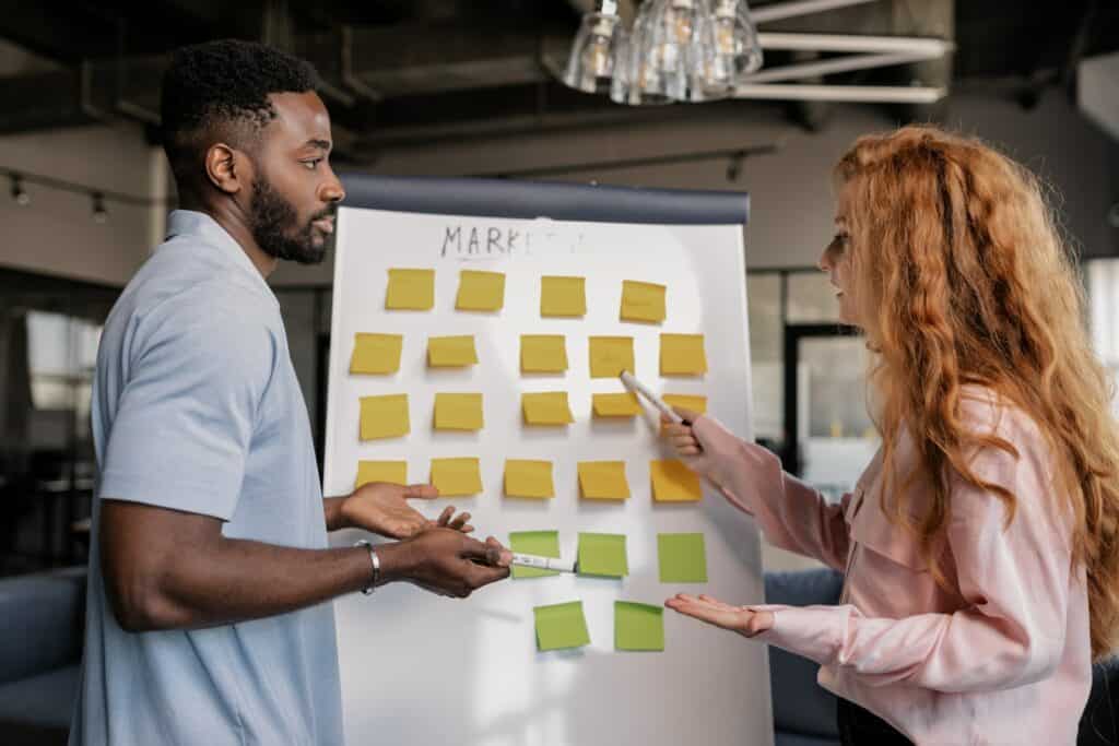 People Having a Meeting in front of a whiteboard